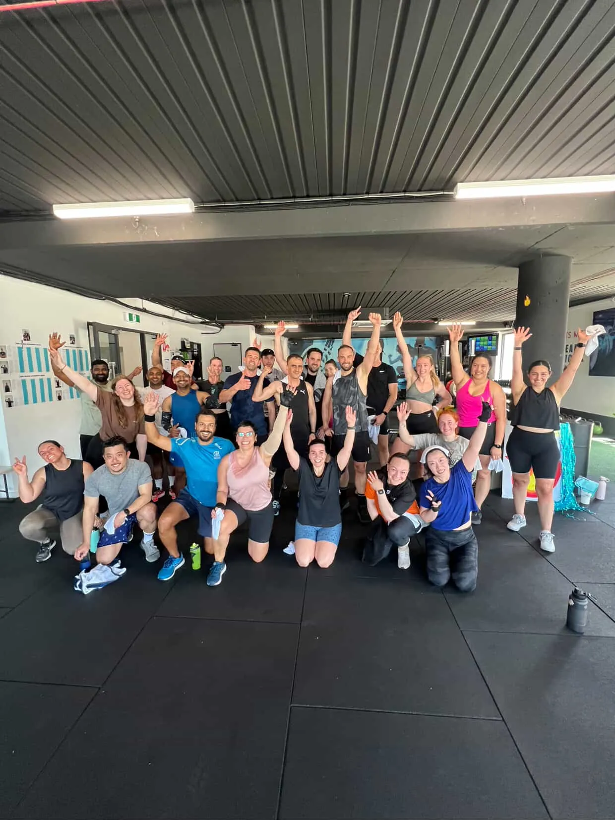 The full BFT Point Cook crew with arms raised on the studio floor