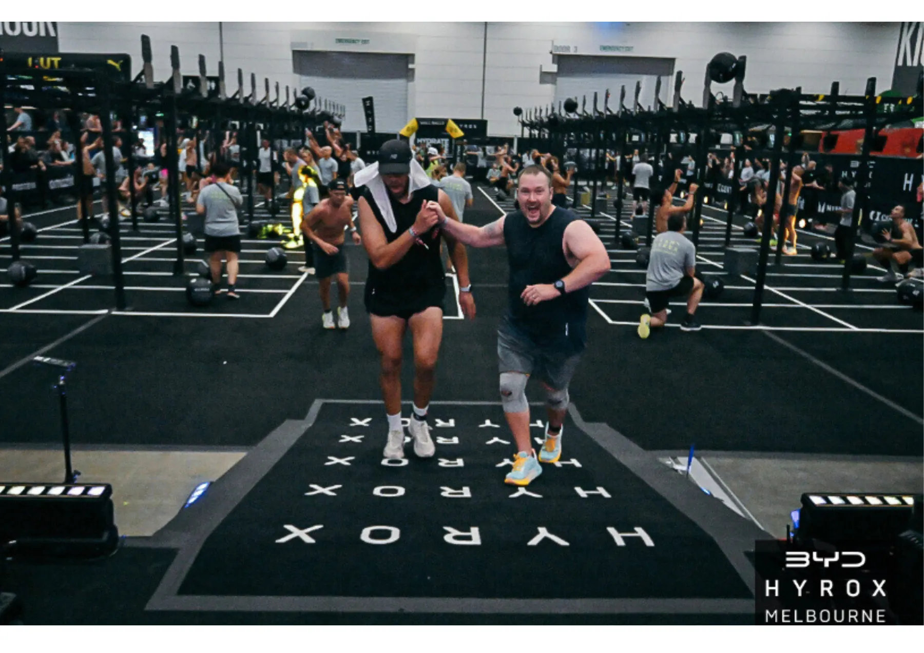 Two BFT athletes celebrating on the HYROX Melbourne competition floor