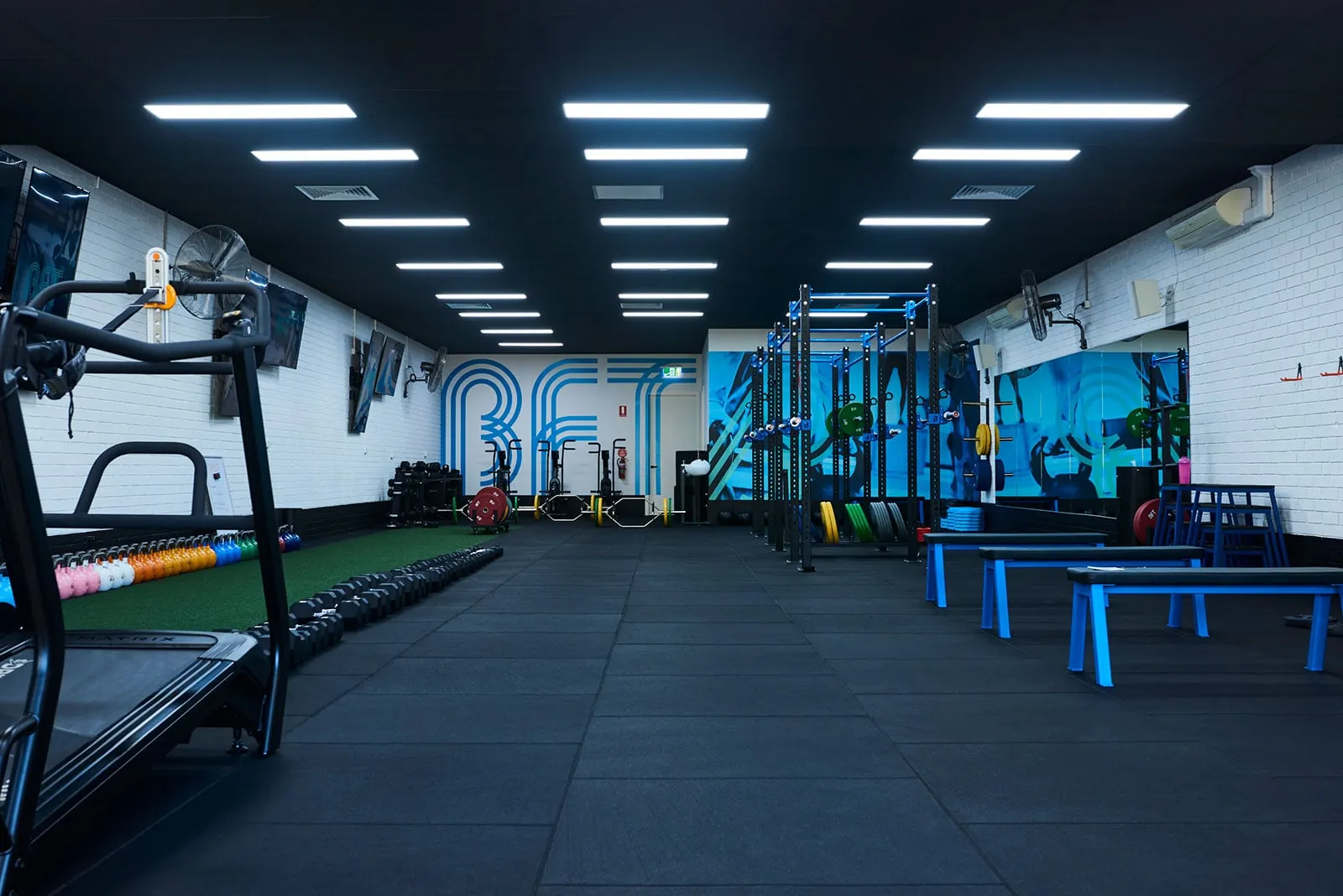The BFT Point Cook training floor with branded signage and treadmills